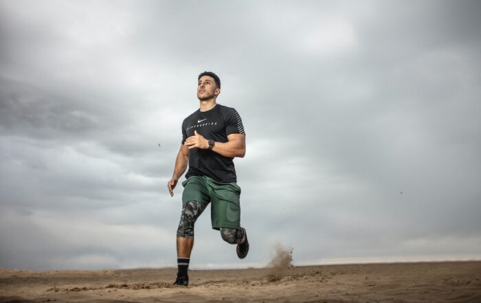 Man performing low-impact exercise in gym attire, demonstrating safe fitness practices for individuals with injuries